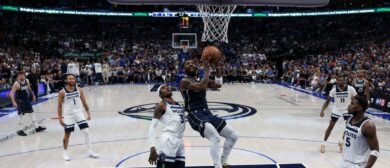 Kyrie Irving #11 of the Dallas Mavericks shoots the ball against Jaden McDaniels #3 of the Minnesota Timberwolves during the fourth quarter in Game Three of the Western Conference Finals at American Airlines Center on May 26, 2024 in Dallas, Texas.