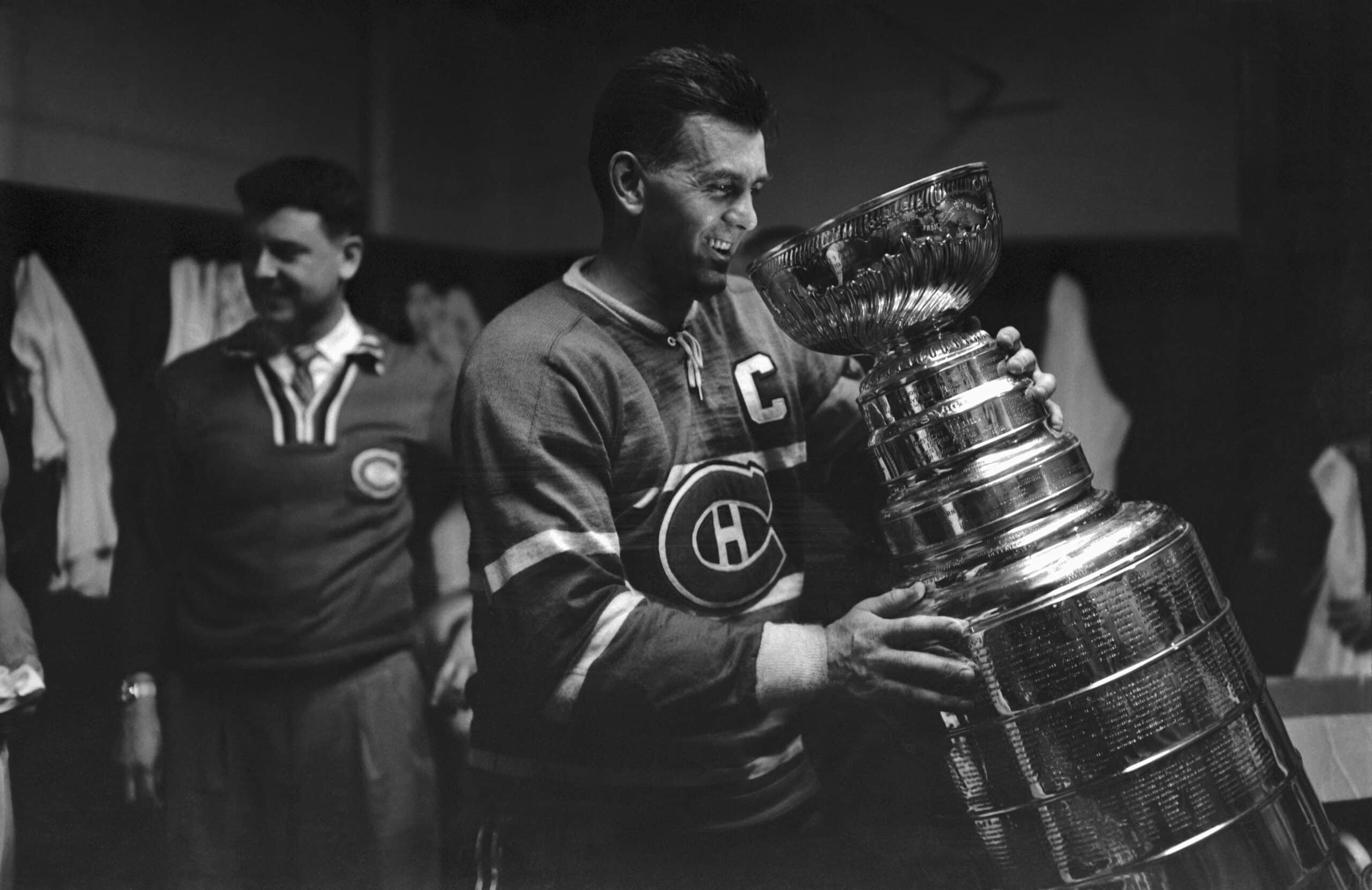 (Original Caption) Maurice "Rocket" Richard, star of the Montreal Canadiens, gets acquainted with the Stanley Cup here April 20th. The Canadiens won the cup by beating the Boston Bruins in the playoffs, 5-3.
