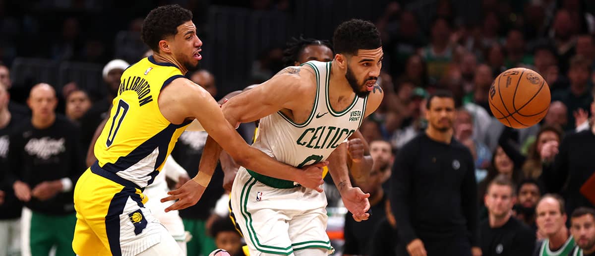 Tyrese Haliburton #0 of the Indiana Pacers fouls Jayson Tatum #0 of the Boston Celtics during overtime in Game One of the Eastern Conference Finals at TD Garden on May 21, 2024 in Boston, Massachusetts.