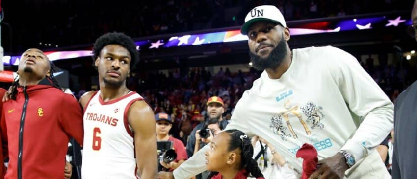 Lakers' LeBron James, right, pats the back of USC Trojans guard Bronny James (6) before the game against the Long Beach State 49ers at Galen Center in Los Angeles Sunday, Dec. 10, 2023