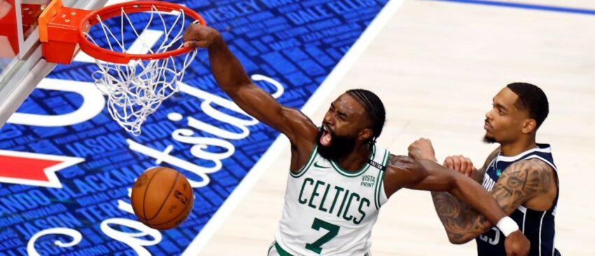 Boston Celtics guard Jaylen Brown (7) slam dunks past Dallas Mavericks forward P.J. Washington (25) during the third quarter in Game 3 of the NBA Finals. The Dallas Mavericks hosted the Boston Celtics at American Airlines Center on Wednesday, June 12, 2024.