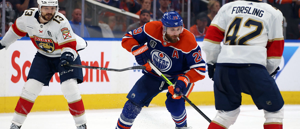 Leon Draisaitl #29 of the Edmonton Oilers controls the puck against Sam Reinhart #13 and Gustav Forsling #42 of the Florida Panthers during the second period of Game Three of the 2024 Stanley Cup Final at Rogers Place on June 13, 2024 in Edmonton, Alberta.