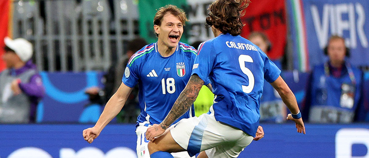Nicolo Barella of Italy celebrates scoring his team's second goal with teammate Riccardo Calafiori during the UEFA EURO 2024 group stage match between Italy and Albania at Football Stadium Dortmund on June 15, 2024 in Dortmund, Germany.