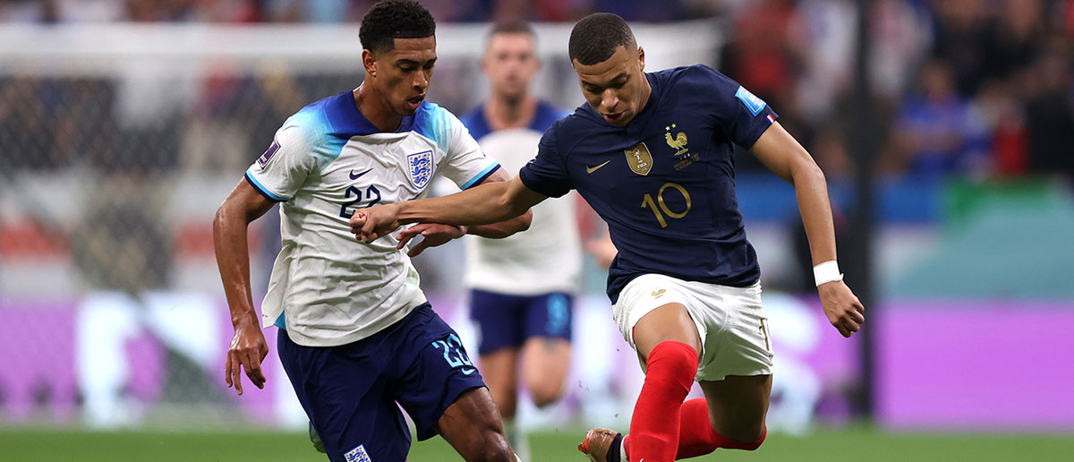 Kylian Mbappe of France controls the ball against Jude Bellingham of England during the FIFA World Cup Qatar 2022 quarter final match between England and France at Al Bayt Stadium on December 10, 2022 in Al Khor, Qatar.
