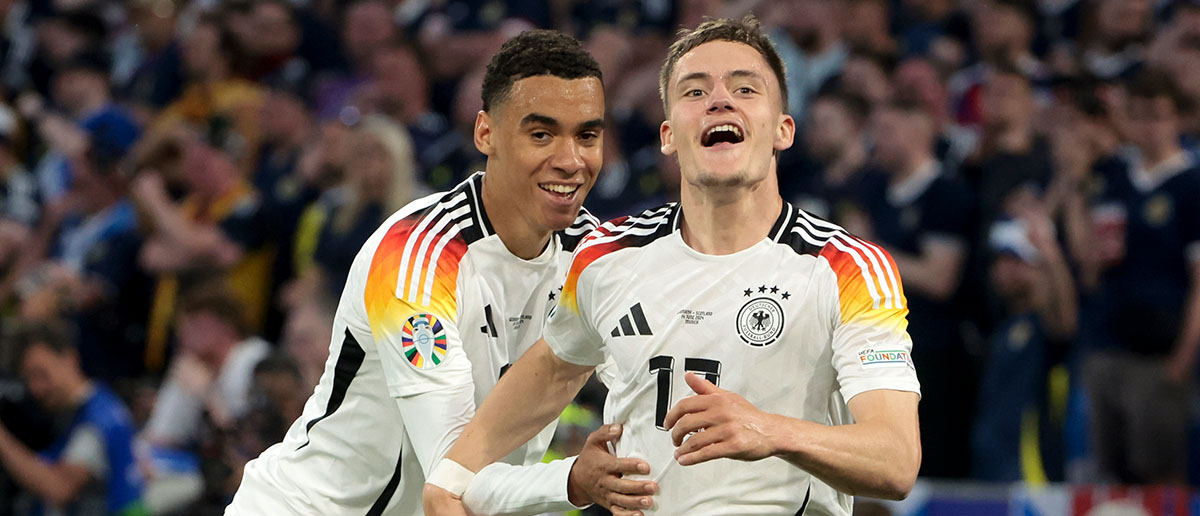 Florian Wirtz of Germany celebrates his goal with Jamal Musiala of Germany (left) during the UEFA EURO 2024 group stage match between Germany and Scotland at Munich Football Arena on June 14, 2024 in Munich, Germany.