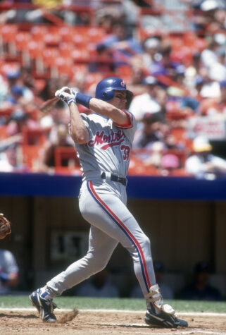 NEW YORK - CIRCA 1993:  Larry Walker #33 of the Montreal Expos swings and watches the flight of his ball against the New York Mets during an Major League Baseball game circa 1993 at Shea Stadium in the Queens borough of New York City.  Walker played for the Expos from 1989-94. (Photo by Focus on Sport/Getty Images)