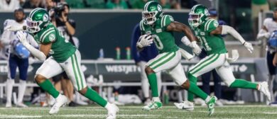 Rolan Milligan Jr. #0 of the Saskatchewan Roughriders returns an interception with some blocking help from teammates in the game between the Toronto Argonauts and Saskatchewan Roughriders at Mosaic Stadium on July 4, 2024 in Regina, Canada