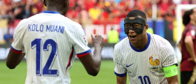 Kylian Mbappe of France, whilst wearing a Black Protective Face Mask, celebrates after teammate Randal Kolo Muani scores his team's first goal during the UEFA EURO 2024 round of 16 match between France and Belgium at Düsseldorf Arena on July 01, 2024 in Dusseldorf, Germany.