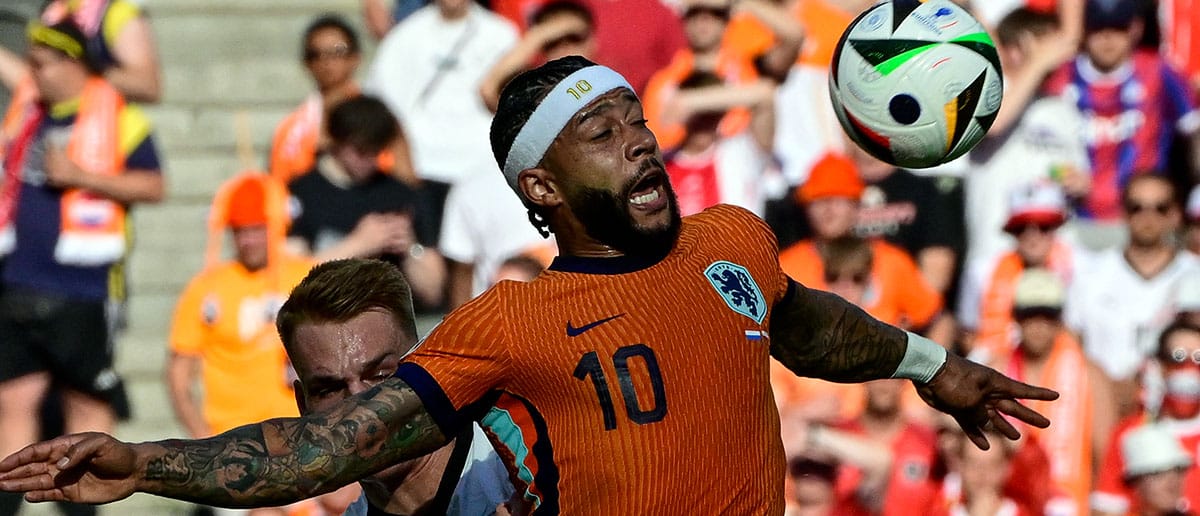 Netherlands' forward #10 Memphis Depay controls the ball past Austria's defender #15 Philipp Lienhart during the UEFA Euro 2024 Group D football match between the Netherlands and Austria at the Olympiastadion in Berlin on June 25, 2024.