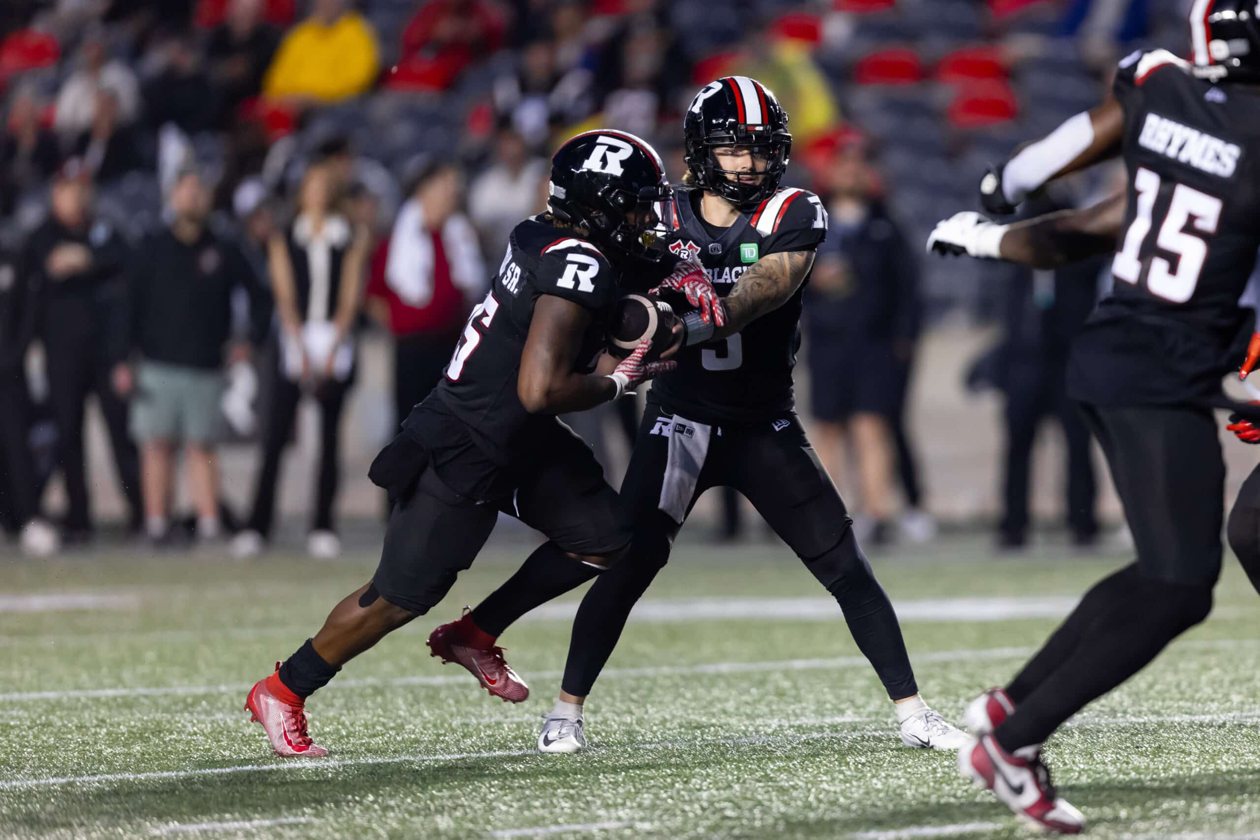 OTTAWA, ON - JUNE 13: Ottawa Redblacks quarterback Dru Brown (3) hands off to running back Ryquell Armstead (25) during Canadian Football League action between the Winnipeg Blue Bombers and Ottawa Redblacks on June 13, 2024, at TD Place at Lansdowne Park in Ottawa, ON, Canada. (Photo by Richard A. Whittaker/Icon Sportswire via Getty Images)