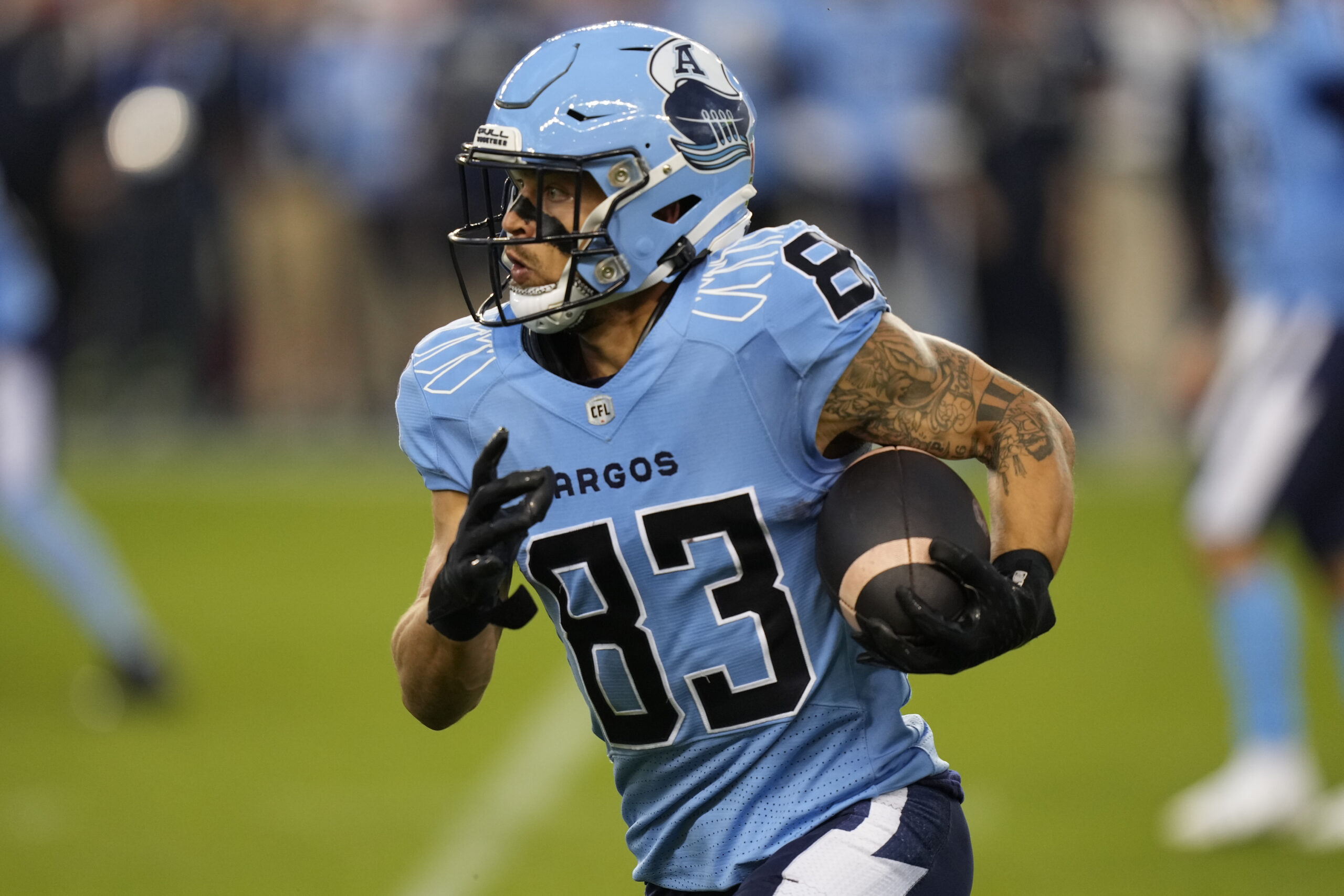 TORONTO, CANADA - AUGUST 22: David Ungerer III #83 of the Toronto Argonauts runs with the ball after a pass reception against the Saskatchewan Roughriders during the first half at BMO Field on August 22, 2024 in Toronto, Canada.  (Photo by John E. Sokolowski/Getty Images)