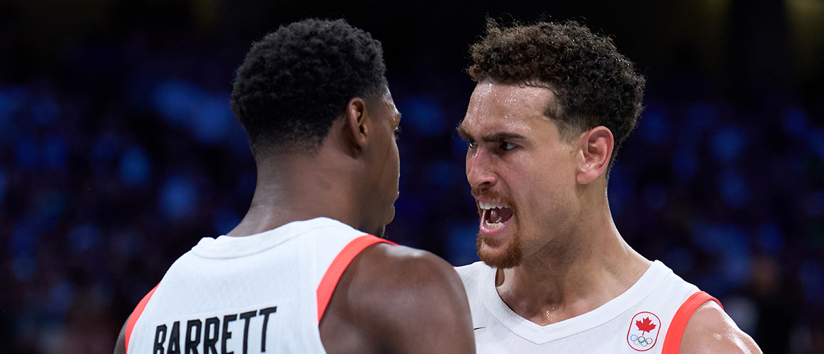 Rj Barrett and Dwight Powell R of Canada react during the men's basketball group A match between Canada and Australia at the Paris 2024 Olympic Games at Pierre Mauroy Stadium in Lille, France, on July 30, 2024