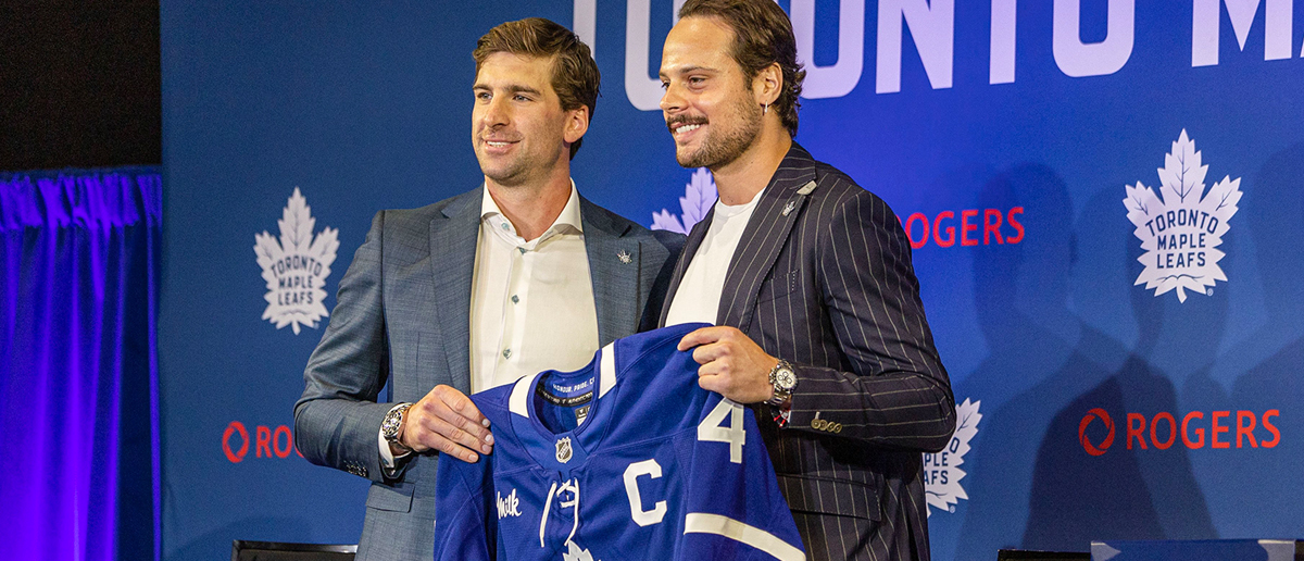 Former Maple Leafs team captain John Tavares presents teammate Auston Matthews with his updated jersey as the 26th captain of the Original Six NHL franchise during a media event in Toronto, August 14, 2024. The 26-year-old superstar has taken over the job from John Tavares, who had been captain since October 2019.