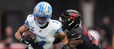 Wide receiver Amon-Ra St. Brown #14 of the Detroit Lions makes a reception past Garrett Williams #21 of the Arizona Cardinals during the NFL game at State Farm Stadium on September 22, 2024 in Glendale, Arizona. The Lions defeated the Cardinals 20-13.