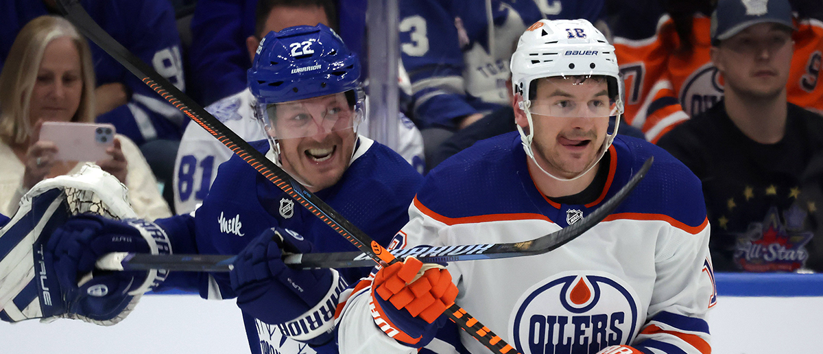 Toronto Maple Leafs defenseman Jake McCabe (22) battles with Edmonton Oilers left wing Zach Hyman (18) as the Toronto Maple Leafs play the Edmonton Oilers at Scotiabank Arena in Toronto. March 23, 2024.