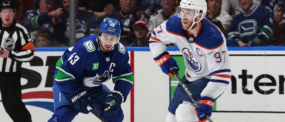 Quinn Hughes #43 of the Vancouver Canucks checks Connor McDavid #97 of the Edmonton Oilers in Game Two of the Second Round of the 2024 Stanley Cup Playoffs at Rogers Arena on May 10, 2024 in Vancouver, British Columbia, Canada.