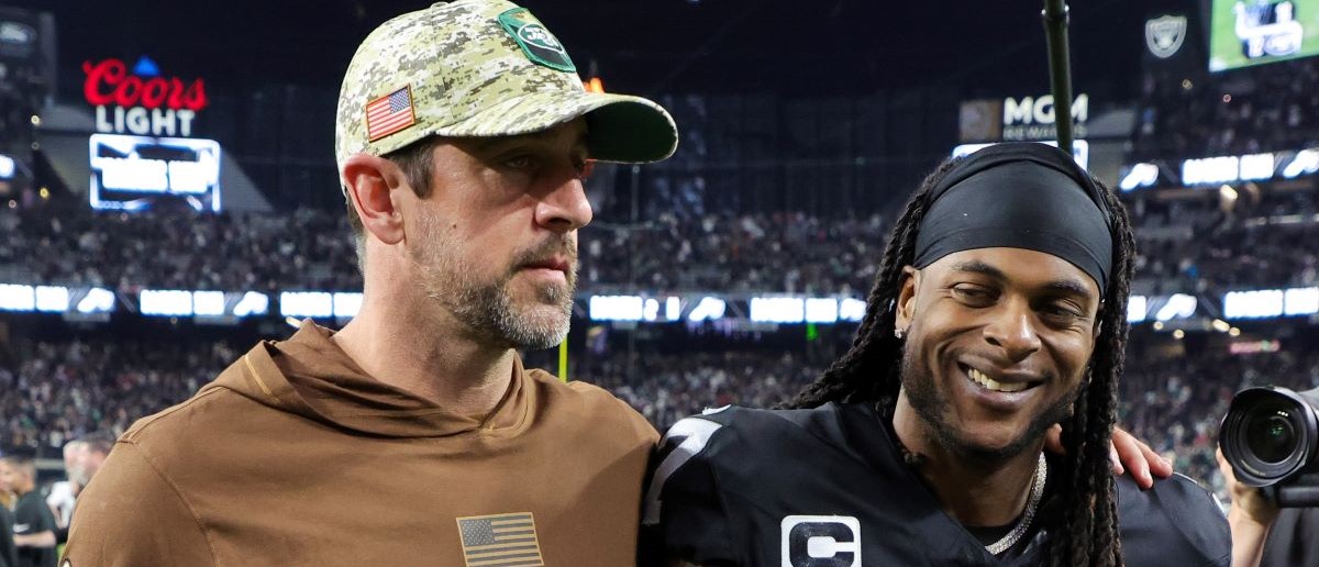 Quarterback Aaron Rodgers #8 of the New York Jets and wide receiver Davante Adams #17 of the Las Vegas Raiders visit on the field after the Raiders' 16-12 victory over the Jets at Allegiant Stadium on November 12, 2023 in Las Vegas, Nevada.