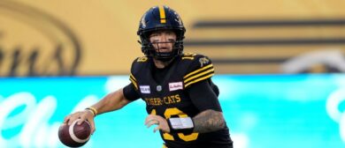 Bo Levi Mitchell #19 of the Hamilton Tiger-Cats rolls out to pass against the Montreal Alouettes at Tim Hortons Field on August 2, 2024 in Hamilton, Canada.