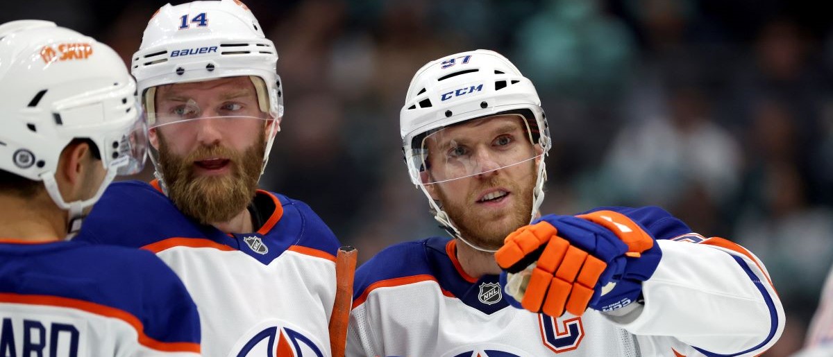 Connor McDavid #97 of the Edmonton Oilers talks with his teammates during the first period against the Seattle Kraken at Climate Pledge Arena on October 02, 2024 in Seattle, Washington.