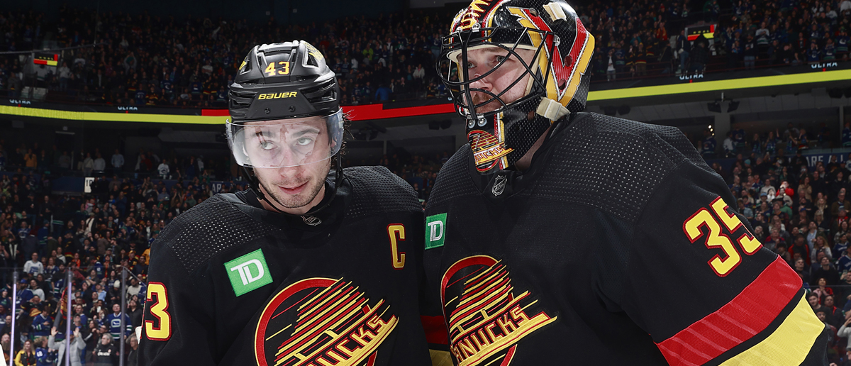 Quinn Hughes #43 of the Vancouver Canucks celebrates with teammate Thatcher Demko #35 after defeating the Columbus Blue Jackets during their NHL game at Rogers Arena on January 27, 2024 in Vancouver, British Columbia, Canada. Vancouver won 5-4.