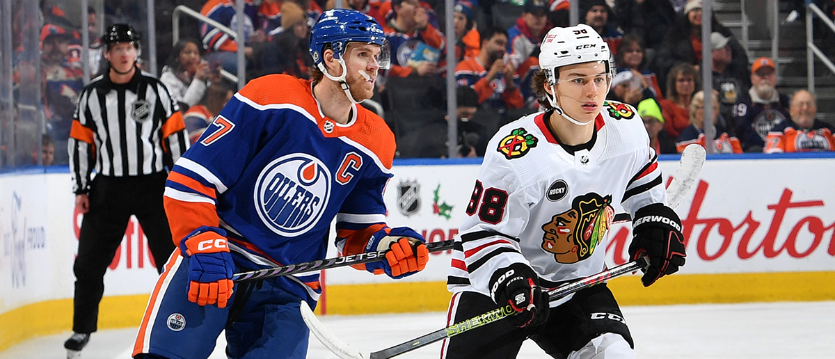 Connor McDavid #97 of the Edmonton Oilers and Connor Bedard #98 of the Chicago Blackhawks skate during the game at Rogers Place on December 12, 2023, in Edmonton, Alberta, Canada.