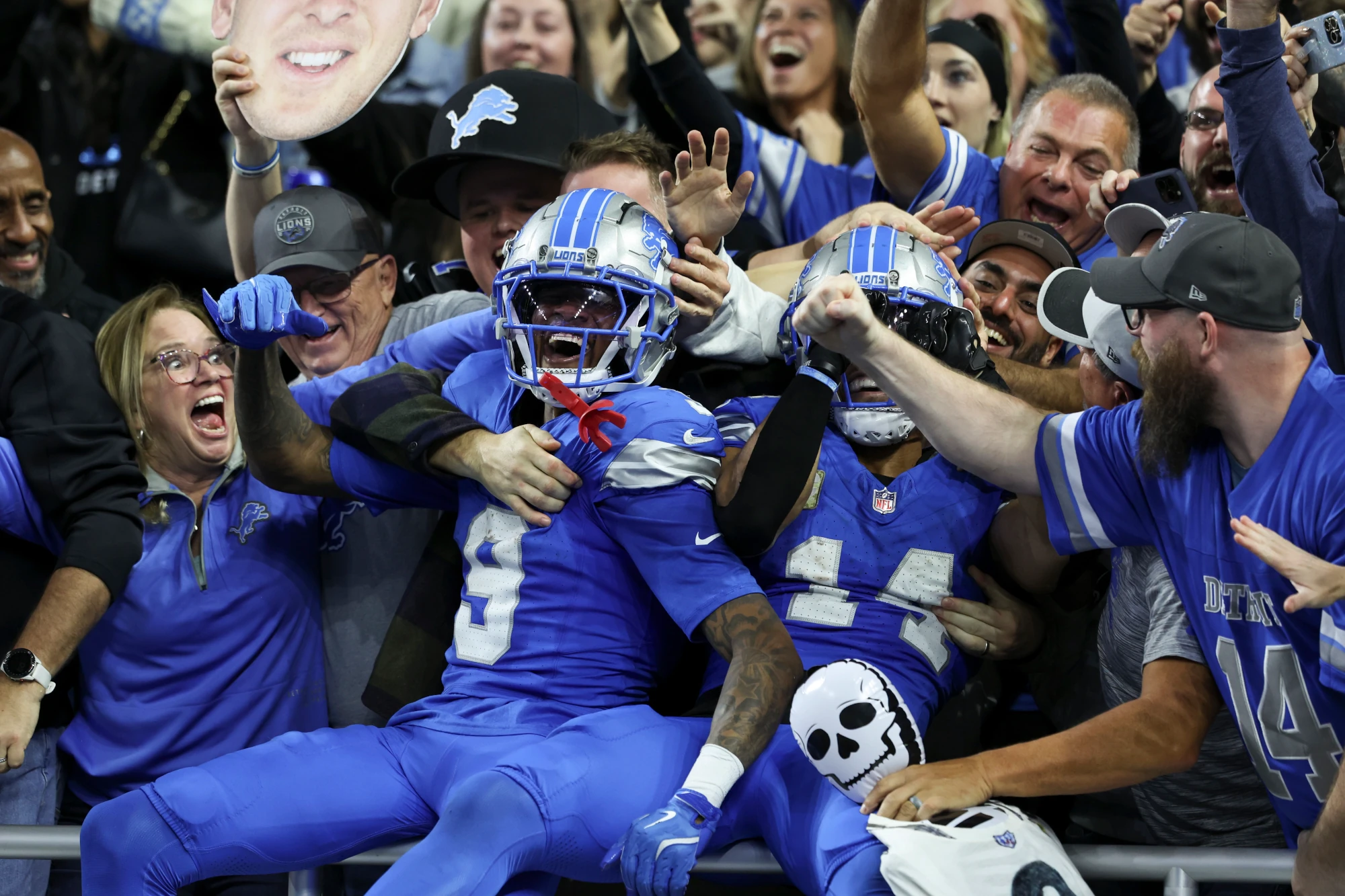 Jameson Williams and Amon-Ra St. Brown of the Detroit Lions celebrate a touchdown with fans during a game against the Jacksonville Jaguars at Ford Field on November 17, 2024 in Detroit, Michigan. The Lions defeated the Jaguars 52-6.