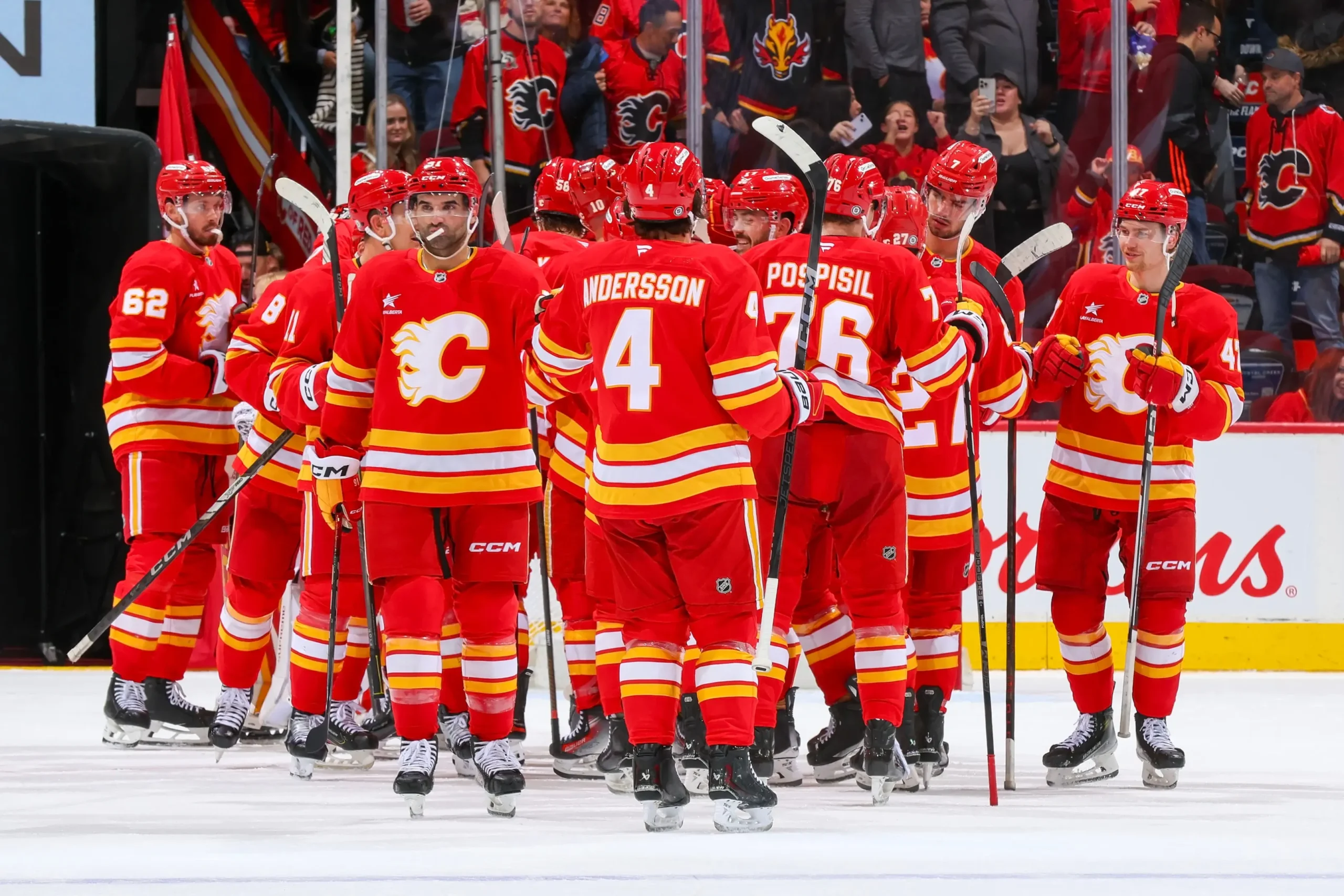  The Calgary Flames celebrate a win against the Los Angeles Kings at Scotiabank Saddledome on November 11, 2024 in Calgary, Alberta, Canada.