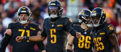 Jayden Daniels #5 of the Washington Commanders reacts after a play against the Chicago Bears during the first half of the game at Northwest Stadium on October 27, 2024 in Landover, Maryland.