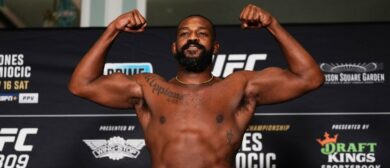 Jon Jones poses on the scale during the UFC 309 official weigh-in at the New York Hilton Midtown on November 15, 2024 in New York City.