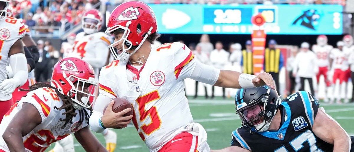 Josey Jewell #47 of the Carolina Panthers tackles Patrick Mahomes #15 of the Kansas City Chiefs during the fourth quarter at Bank of America Stadium on November 24, 2024 in Charlotte, North Carolina