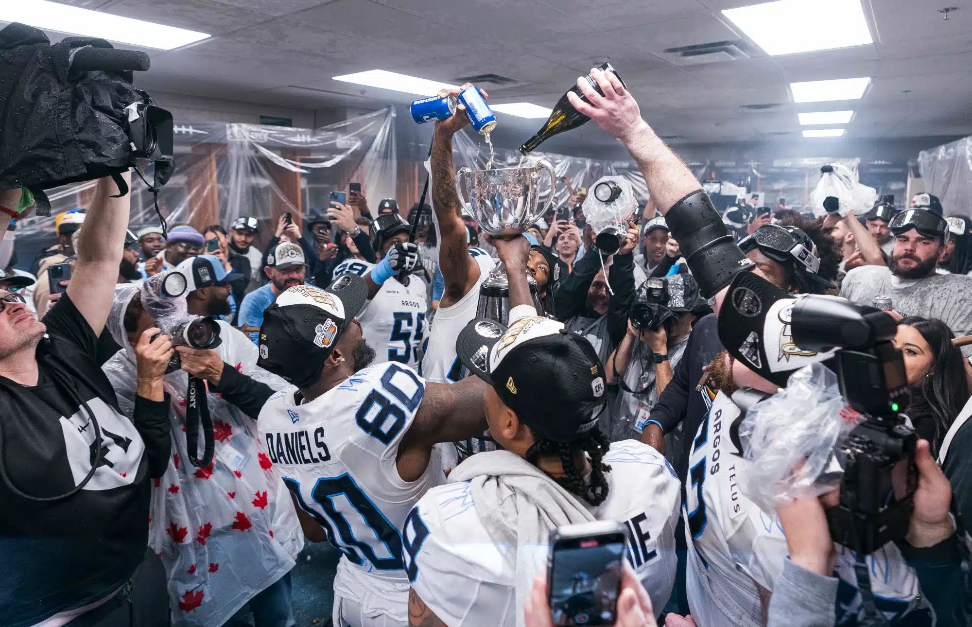 Toronto Argonauts players fills the Grey Cup with beer and champagne in the locker room after defeating the Winnipeg Blue Bombers 41-24 to win the 2024 Grey Cup at BC Place on November 17, 2024 in Vancouver, Canada.