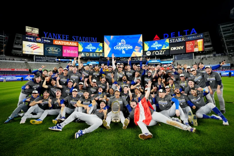 Members of the Los Angeles Dodgers pose for a team photo on the field after the Dodgers defeated the New York Yankees in Game 5 to clinch the 2024 World Series presented by Capital One at Yankee Stadium on Wednesday, October 30, 2024 in New York, New York.