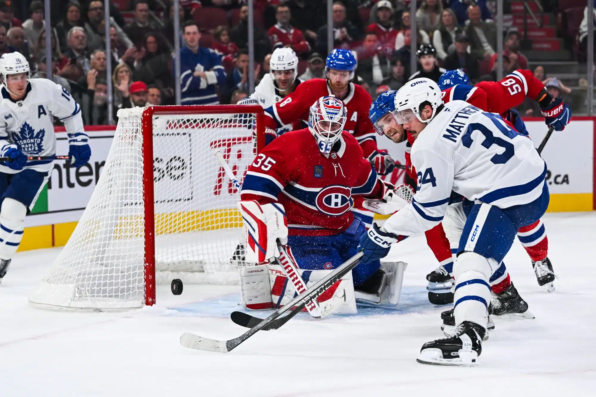 Montreal Canadiens goalie Sam Montembeault makes a save against Toronto Maple Leafs center Auston Matthews during the game on October 09, 2024, at Bell Centre in Montreal, QC.