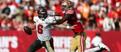 Tampa Bay Buccaneers quarterback Baker Mayfield (6) is pressured by San Francisco 49ers defensive end Leonard Floyd (56) in the fourth quarter at Raymond James Stadium.