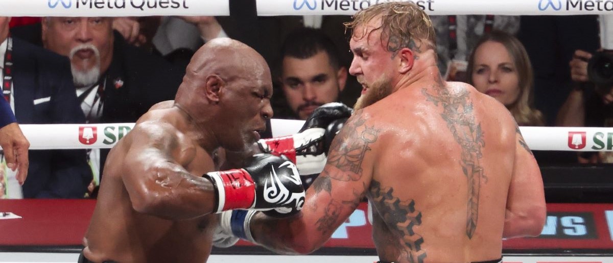 Mike Tyson (black gloves) fights Jake Paul (silver gloves) at AT&T Stadium.