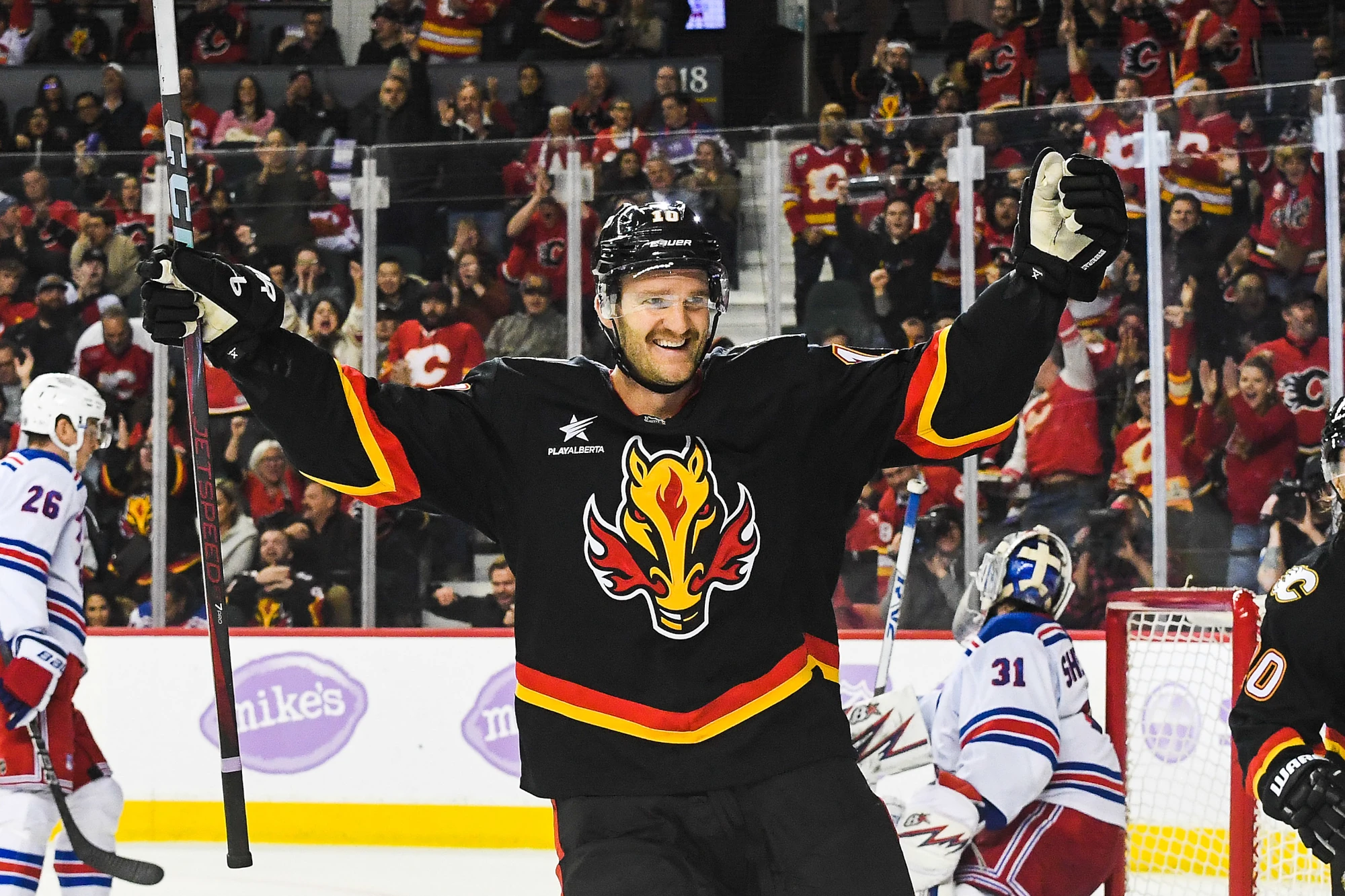 Jonathan Huberdeau of the Calgary Flames celebrates after a goal scored against the New York Rangers during an NHL game at Scotiabank Saddledome on November 21, 2024 in Calgary, Alberta, Canada. 