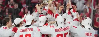 Team Canada celebrates with IIHF World Junior Championship trophy after winning gold.