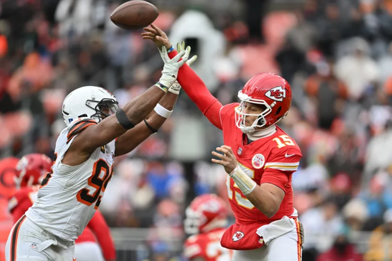 Patrick Mahomes #15 of the Kansas City Chiefs throws a pass under pressure from Myles Garrett #95 of the Cleveland Browns during the third quarter at Huntington Bank Field on December 15, 2024 in Cleveland, Ohio.