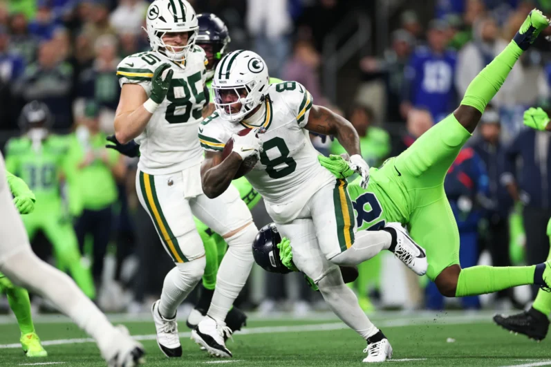 Josh Jacobs #8 of the Green Bay Packers carries the ball against the Seattle Seahawks during the first quarter of the game at Lumen Field on December 15, 2024 in Seattle, Washington. 