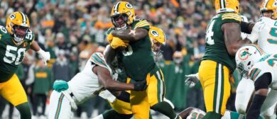 Josh Jacobs #8 of the Green Bay Packers carries the ball against the Miami Dolphins during the first quarter of the game at Lambeau Field on November 28, 2024 in Green Bay, Wisconsin.