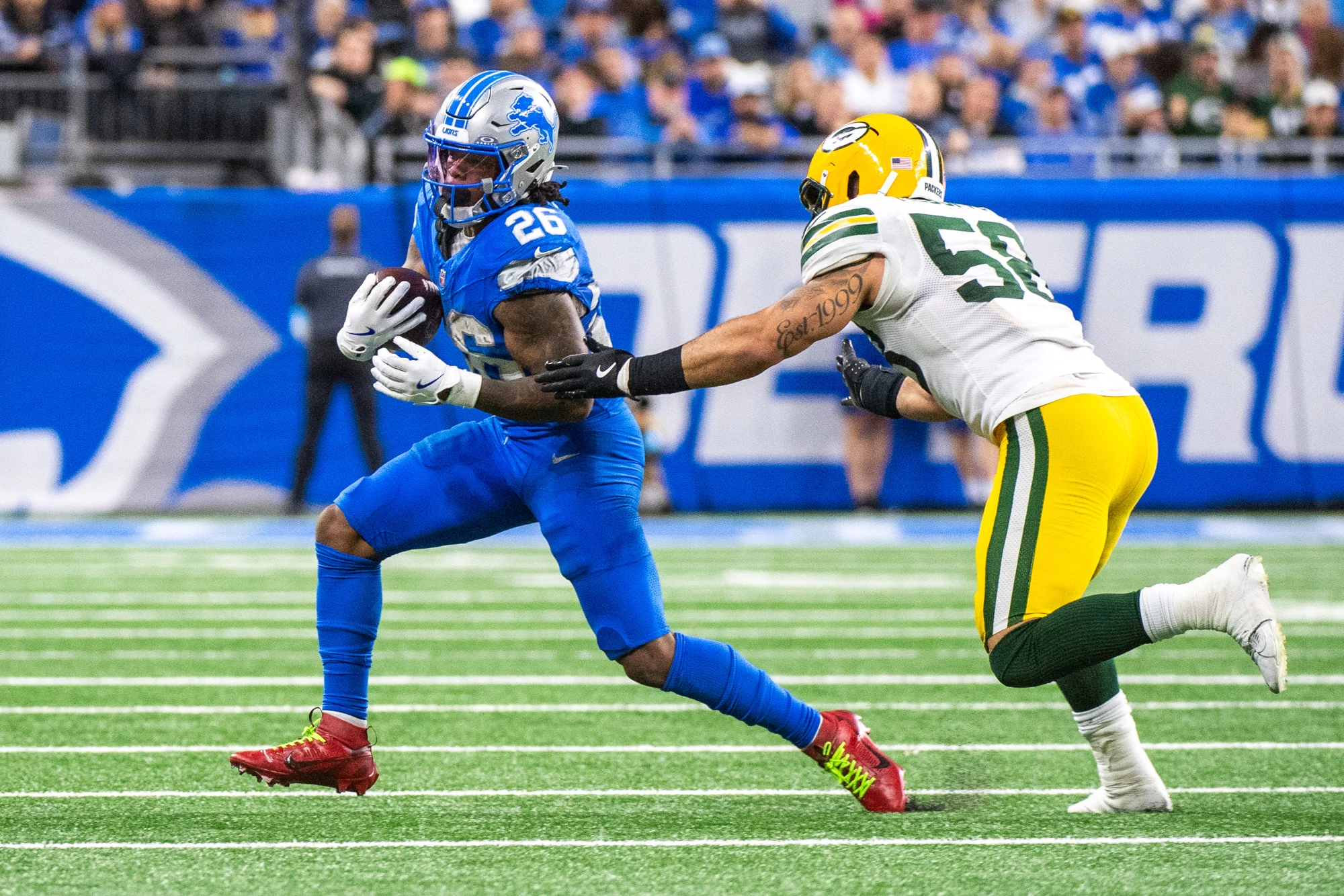 Jahmyr Gibbs #26 of the Detroit Lions runs with the ball away from a tackle by Isaiah McDuffie #58 of the Green Bay Packers during the fourth quarter of a NFL game at Ford Field on December 05, 2024 in Detroit, Michigan. The Detroit Lions won the game 34-31 and have the best Super Bowl odds for 2025.