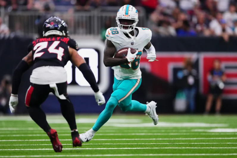 Grant DuBose #88 of the Miami Dolphins runs with the ball against the Houston Texans during the first half of an NFL football game at NRG Stadium on December 15, 2024 in Houston, Texas.