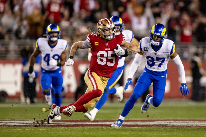 George Kittle #85 of the San Francisco 49ers runs with the ball during an NFL Football game against the Los Angeles Rams at Levi's Stadium on December 12, 2024 in Santa Clara, California. 