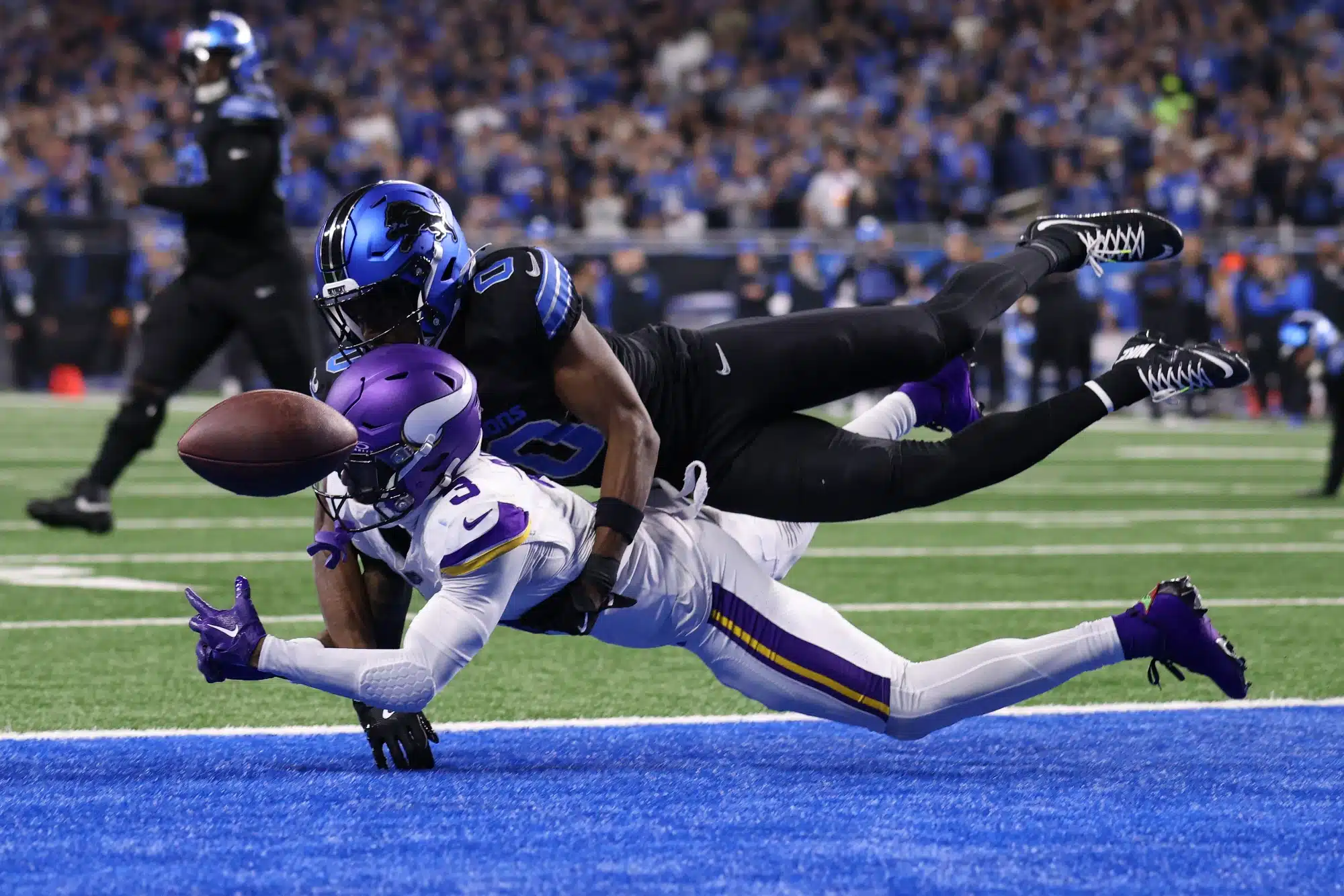  Terrion Arnold #0 of the Detroit Lions breaks up a pass intended for Jordan Addison #3 of the Minnesota Vikings during the third quarter at Ford Field on January 05, 2025 in Detroit, Michigan. 