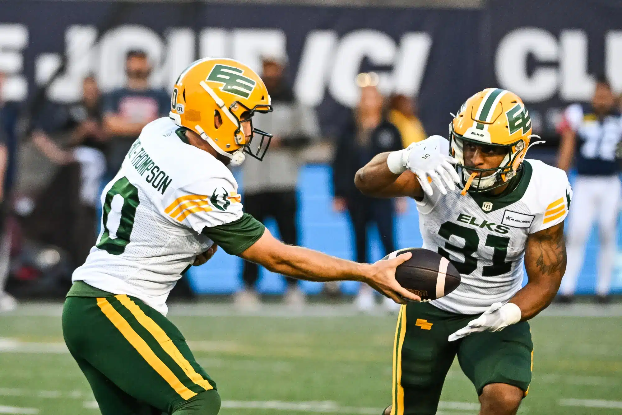 Edmonton Elks quarterback McLeod Bethel-Thompson (10) hands the ball off to Edmonton Elks running back Justin Rankin (31) during the Edmonton Elks versus the Montreal Alouettes game on August 25, 2024, at Percival Molson Memorial Stadium in Montreal, QC