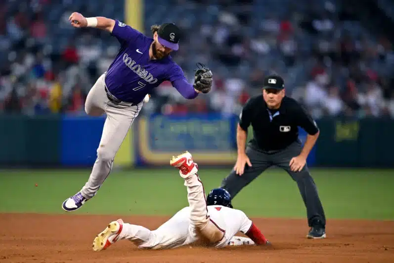 Jo Adell #7 of the Los Angeles Angels steals second base ahead of the tag by Brendan Rodgers #7 of the Colorado Rockies during the fifth inning at Angel Stadium of Anaheim on August 01, 2024 in Anaheim, California.