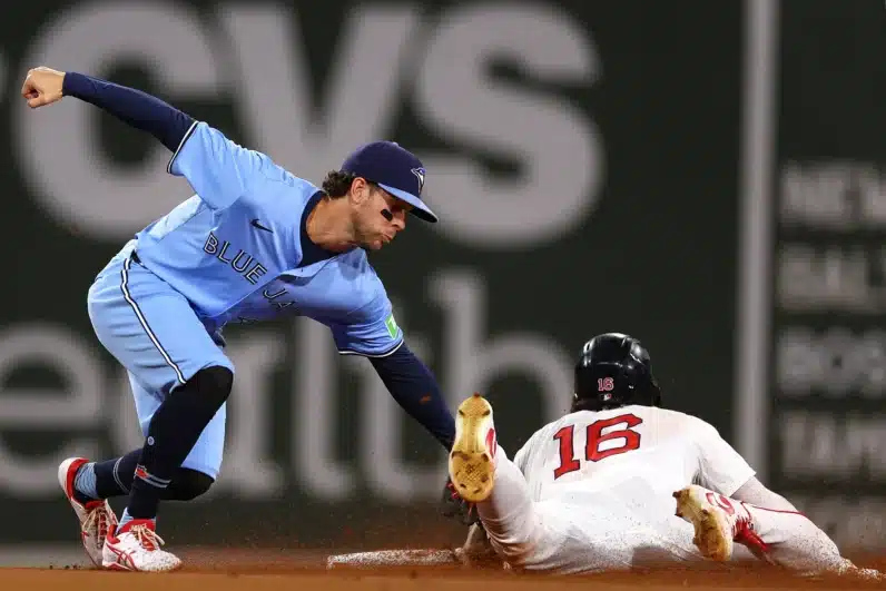 Jarren Duran #16 of the Boston Red Sox is tagged out by Ernie Clement #28 of the Toronto Blue Jays after attempting to steal second base during the fourth inning at Fenway Park on August 29, 2024 in Boston, Massachusetts.