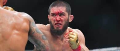 Islam Makhachev (red gloves) fights Dustin Poirier (blue gloves) during UFC 302 at Prudential Center.