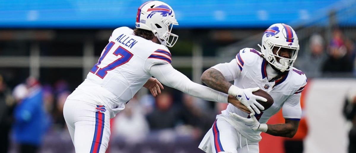 Buffalo Bills quarterback Josh Allen (17) hands off the ball to running back James Cook (4) against the New England Patriots in the first quarter at Gillette Stadium.