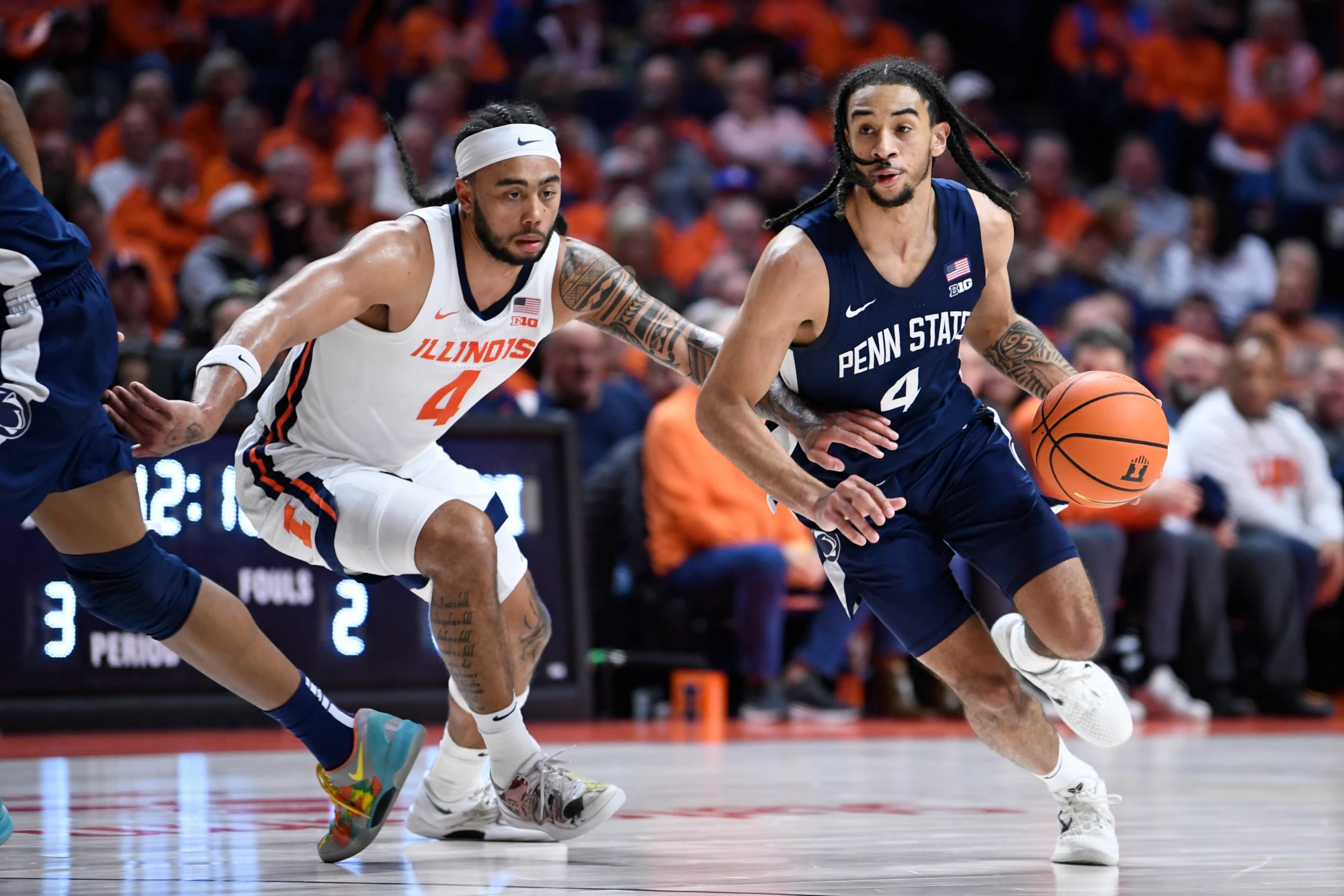 Penn State Nittany Lions Guard Freddie Dilione V dribbles as Illinois Fighting Illini Guard Kylan Boswell defends during the college basketball game between the Penn State Nittany Lions and the Illinois Fighting Illini on January 8, 2025, at the State Farm Center in Champaign, Illinois. 